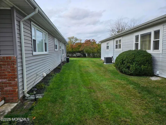 a view of a backyard with plants and a garden