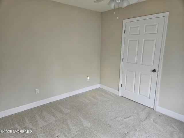 a view of an empty room and entryway