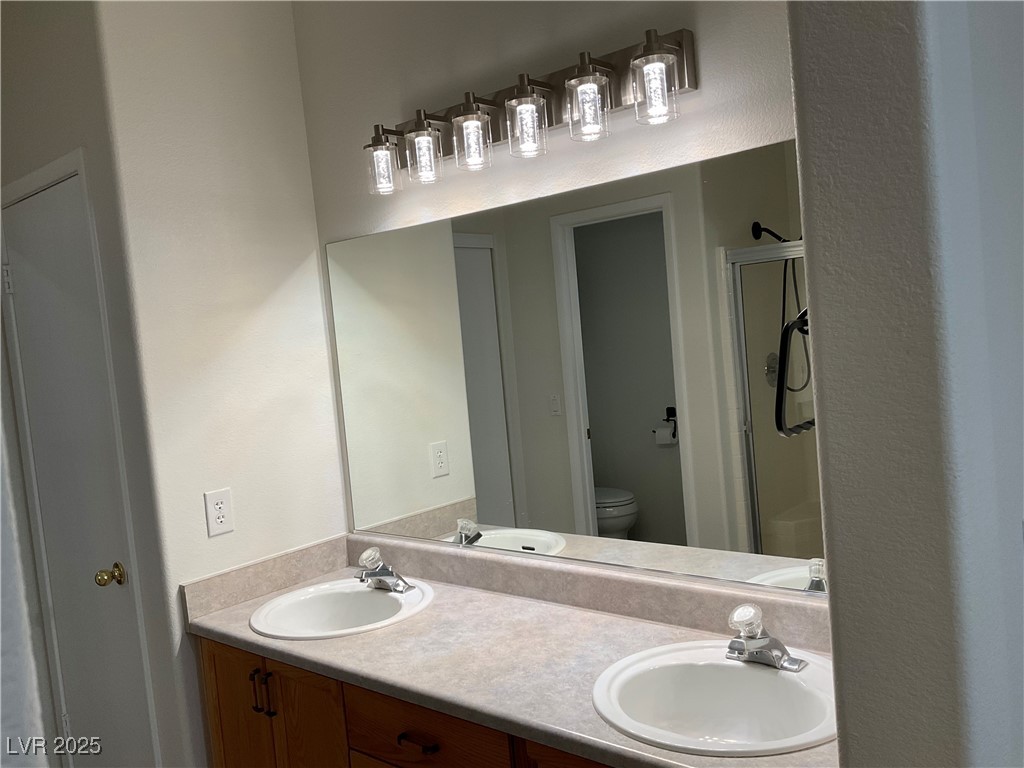 7620 Donald Nelson Avenue Las Vegas, NV 89131 - Photo 18 of 34 Full bathroom with toilet, a shower with door, and double vanity