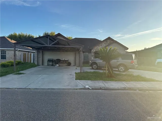 a view of a house with a yard and a street