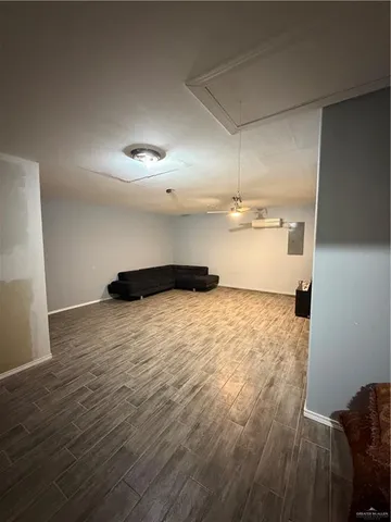 a view of empty room with wooden floor