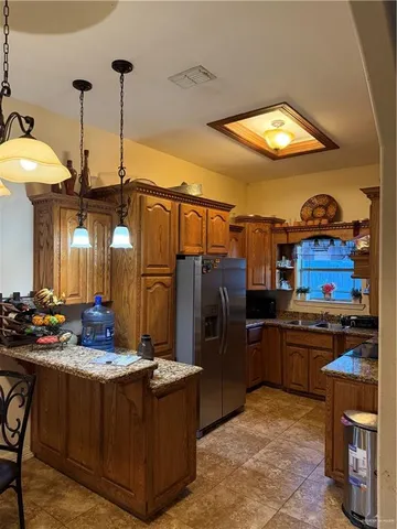 a kitchen with stainless steel appliances granite countertop a stove and a refrigerator