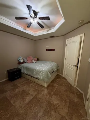 a bedroom with a bed and a ceiling fan