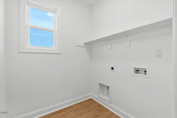 a view of a bedroom with a window and a ceiling fan