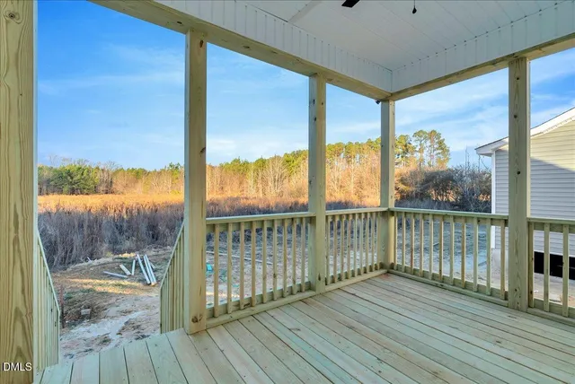 a view of a balcony with wooden floor