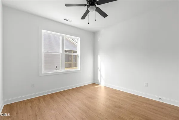 a view of walk in closet with wooden floor