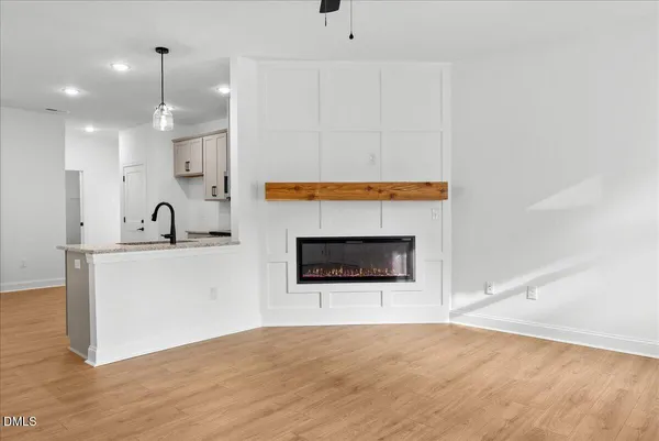 a view of a kitchen with a sink and a fireplace