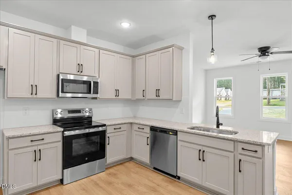 a kitchen with a sink stove and microwave