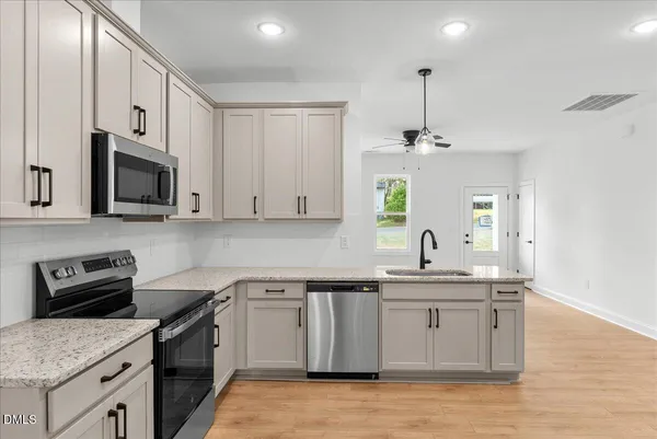 a kitchen with a stove and a microwave