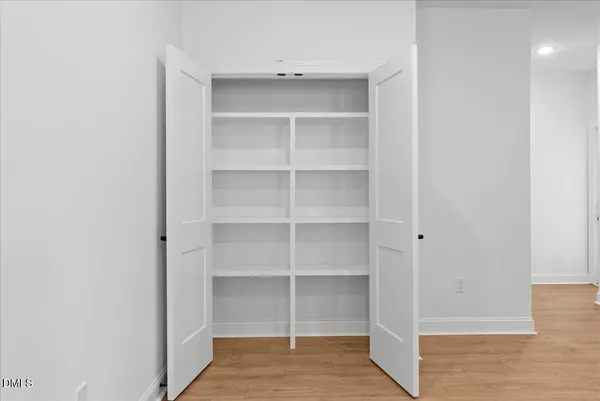 a view of an empty room with a fireplace and a window