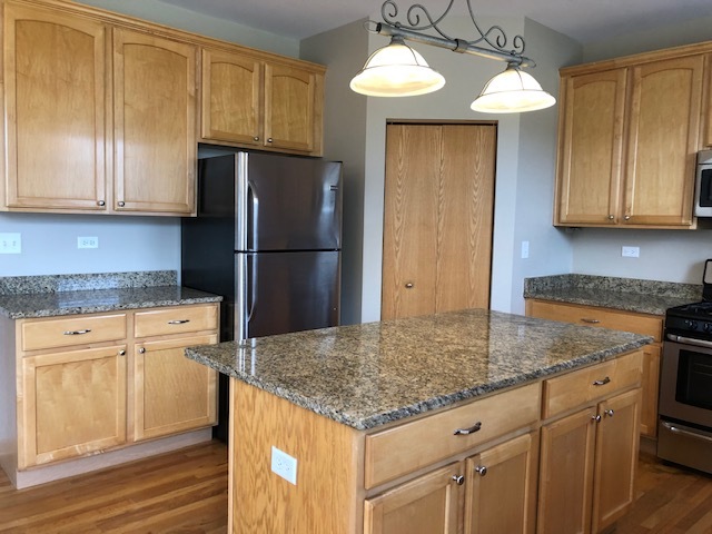 2845 Berman Road North Aurora, IL 60542 - Photo 12 of 23 a kitchen with granite countertop a refrigerator a stove and a sink