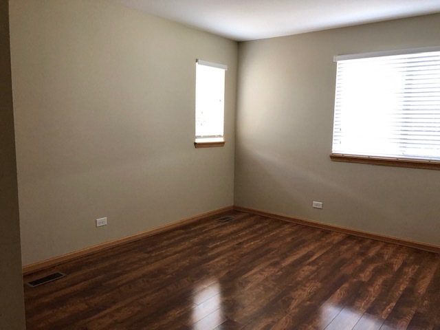 2845 Berman Road North Aurora, IL 60542 - Photo 16 of 23 an empty room with wooden floor and windows