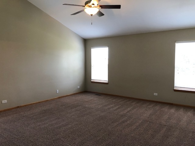 2845 Berman Road North Aurora, IL 60542 - Photo 18 of 23 an empty room with a chandelier fan and windows