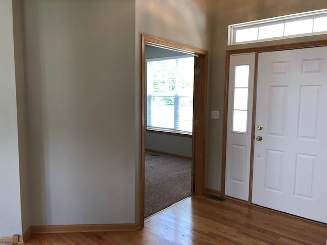2845 Berman Road North Aurora, IL 60542 - Photo 3 of 23 a view of an empty room with wooden floor and a window