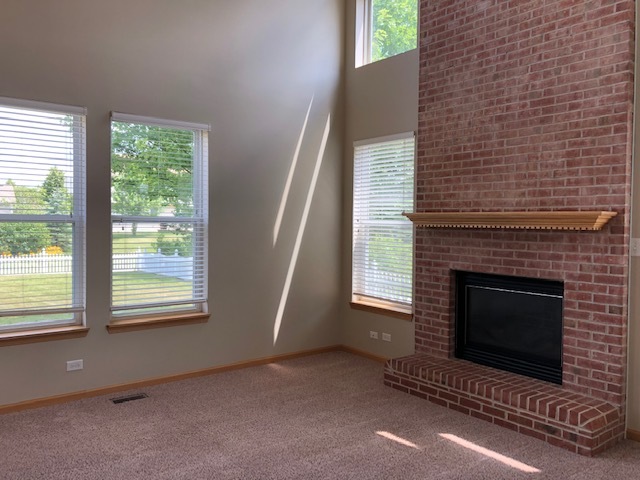 2845 Berman Road North Aurora, IL 60542 - Photo 6 of 23 a living room with a fireplace and a large window