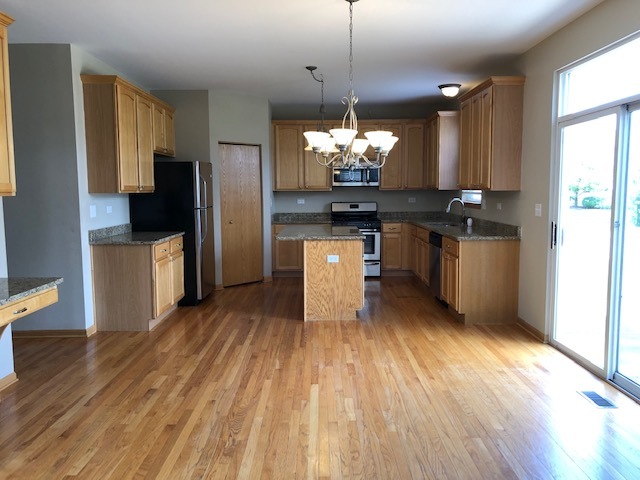 2845 Berman Road North Aurora, IL 60542 - Photo 10 of 23 a kitchen with stainless steel appliances kitchen island granite countertop a refrigerator a stove a sink and a microwave