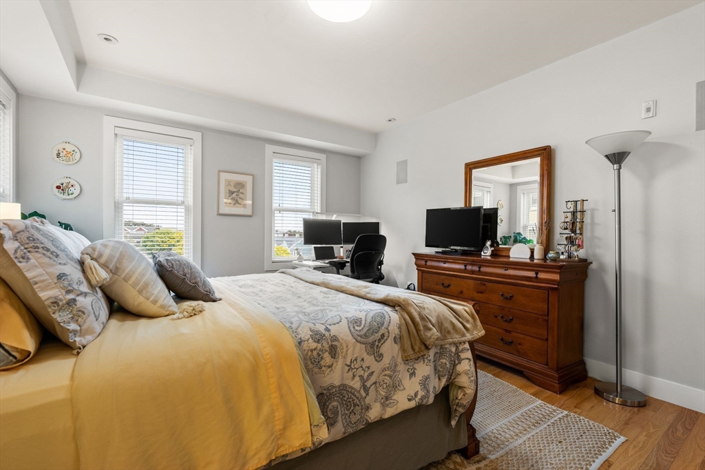339 West Broadway, Unit 12 Boston, MA 02127 - Photo 13 of 23 a bedroom with a bed and wooden floor