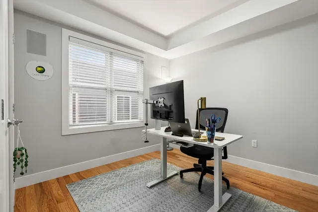 a view of a workspace with furniture and a window