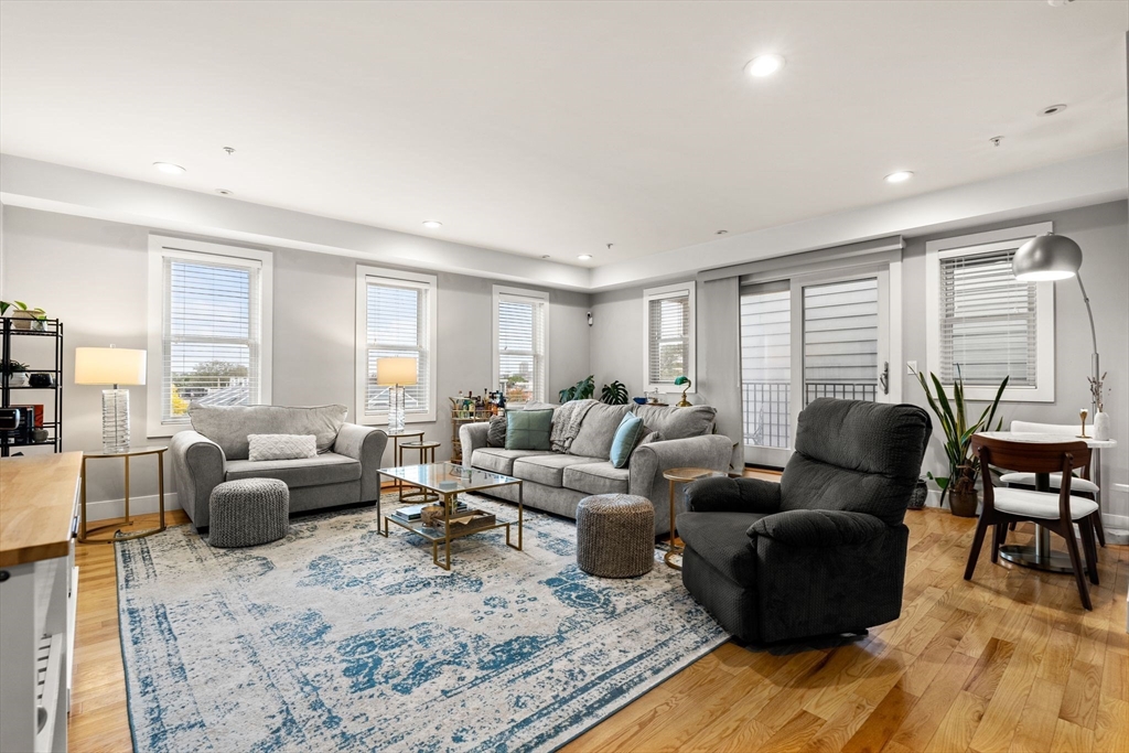 339 West Broadway, Unit 12 Boston, MA 02127 - Photo 8 of 23 a living room with furniture wooden floor and a large window