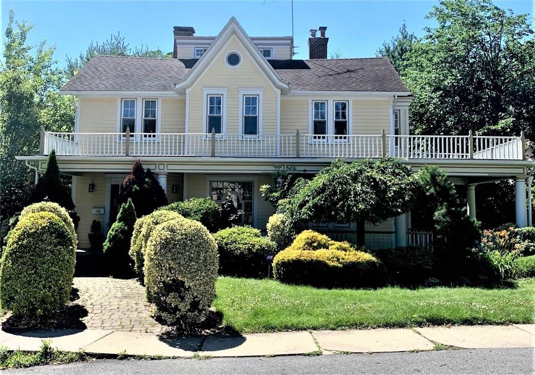 158 Sutton Manor Road New Rochelle, NY 10801 - Photo 1 of 1 a front view of house with yard and green space
