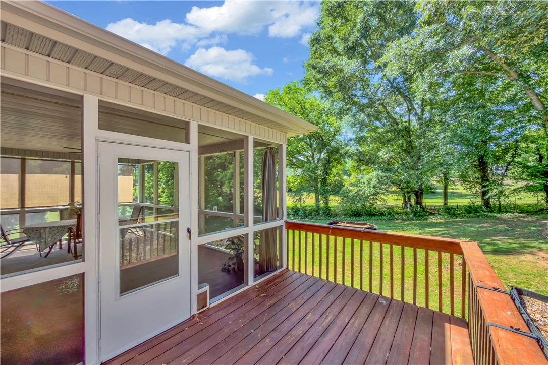406 Hopewell Ridge Anderson, SC 29621 - Photo 38 of 46 This spacious wooden deck extends to a screened-in porch, overlooking lush greenery and an expansive yard.