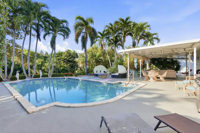 a bedroom with a bed and a chandelier fan
