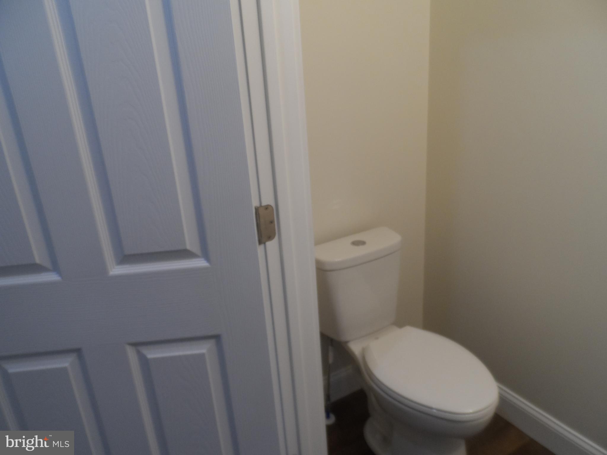 1335 Nottingham Way Hamilton, NJ 08609 - Photo 13 of 40 a white toilet sitting next to a small window