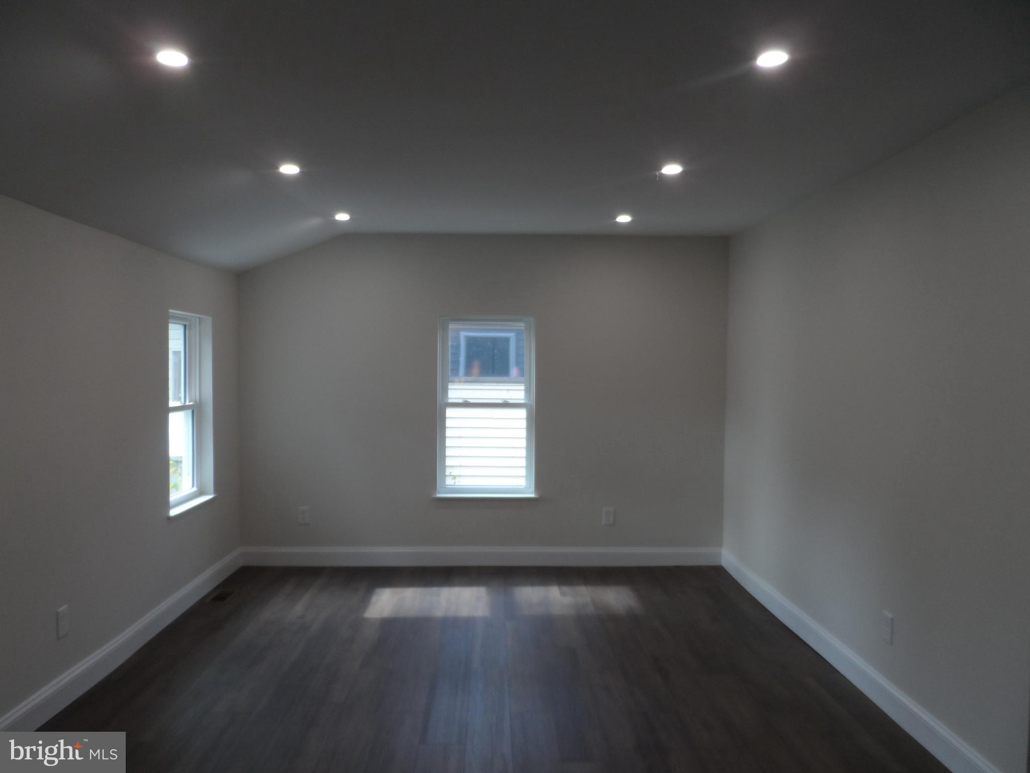 1335 Nottingham Way Hamilton, NJ 08609 - Photo 16 of 40 an empty room with wooden floor and windows