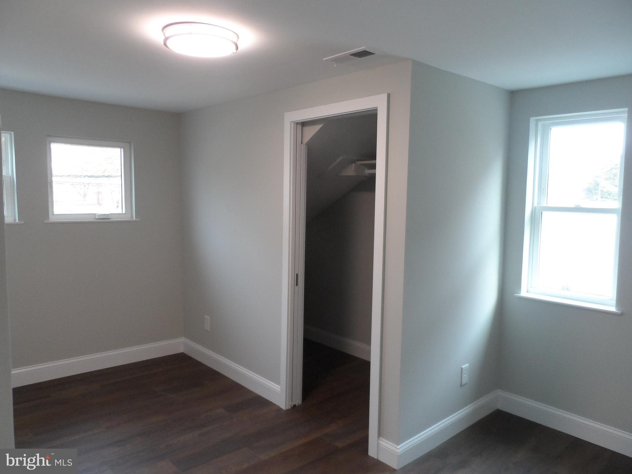 1335 Nottingham Way Hamilton, NJ 08609 - Photo 23 of 40 an empty room with wooden floor and windows