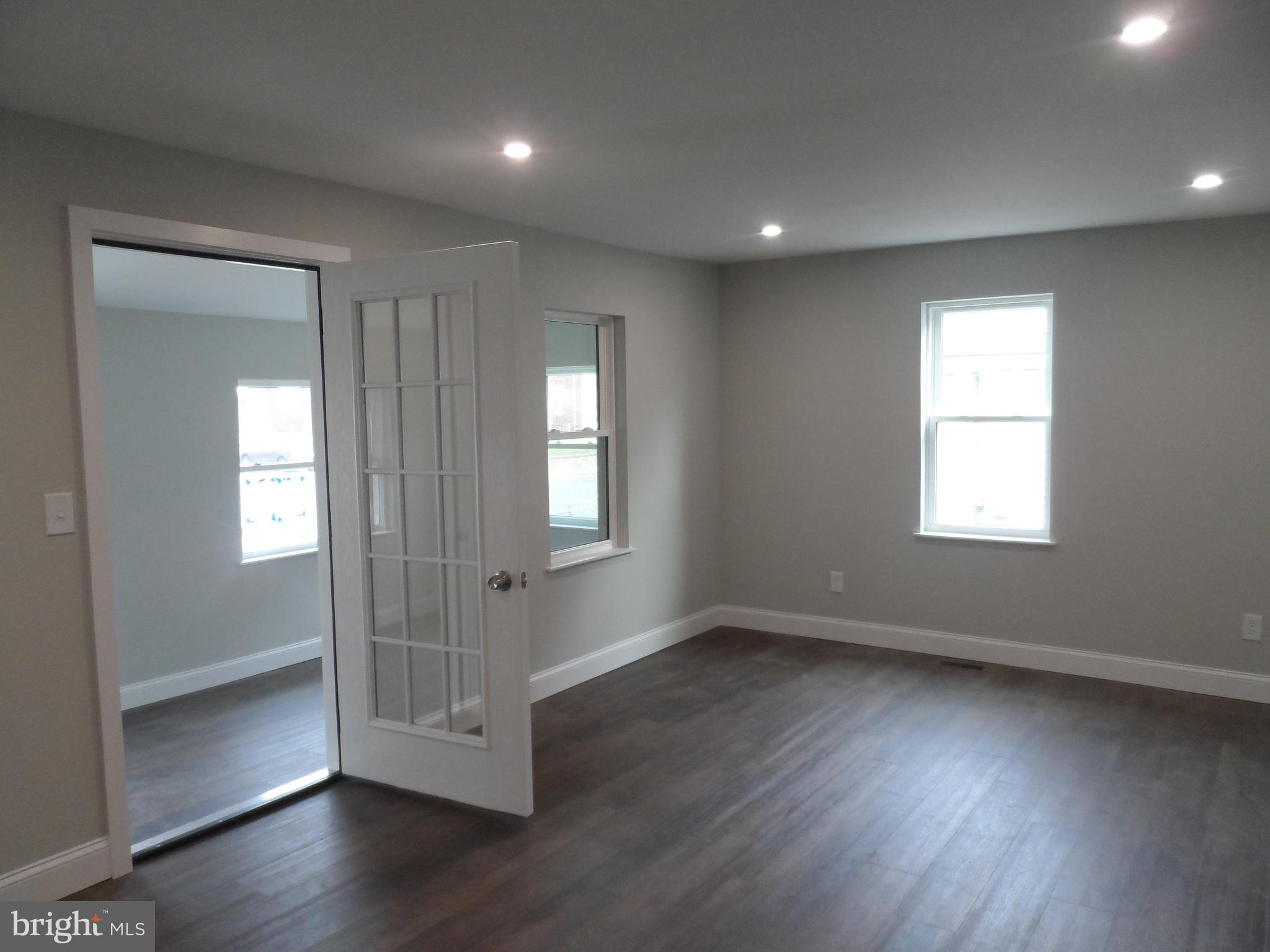 1335 Nottingham Way Hamilton, NJ 08609 - Photo 4 of 40 a view of empty room with wooden floor and fan
