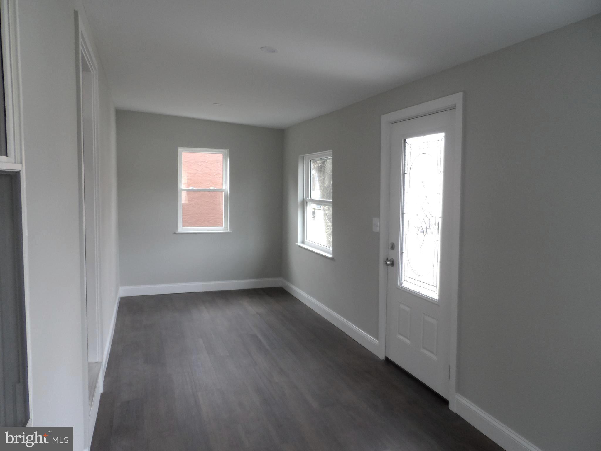 1335 Nottingham Way Hamilton, NJ 08609 - Photo 7 of 40 a view of an empty room with wooden floor and a window