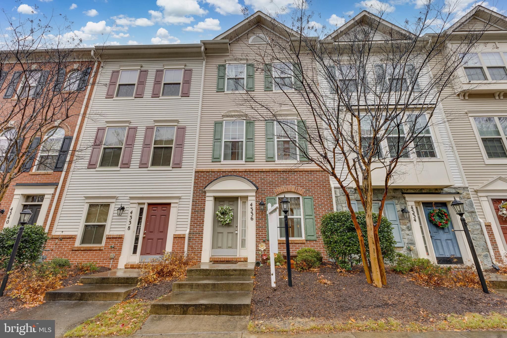 4336 Potomac Highlands Circle, Unit 51 Triangle, VA 22172 - Photo 1 of 40 a front view of a residential apartment building with a yard