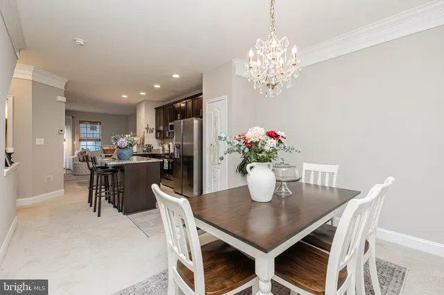a dining room with furniture and chandelier