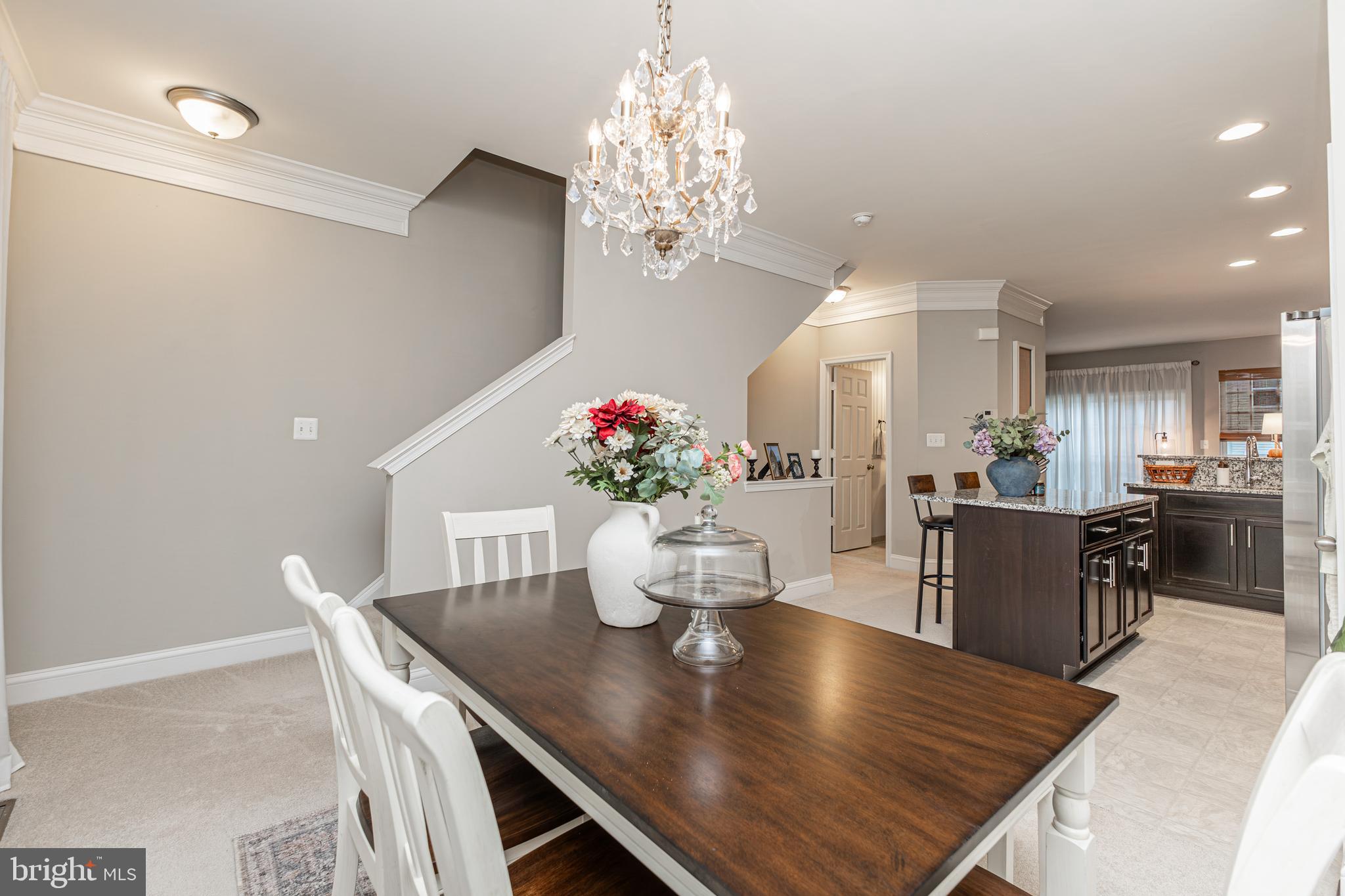 4336 Potomac Highlands Circle, Unit 51 Triangle, VA 22172 - Photo 15 of 40 a view of a dining room with furniture a chandelier and wooden floor