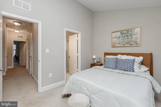 a bedroom with a bed and painting on the wall