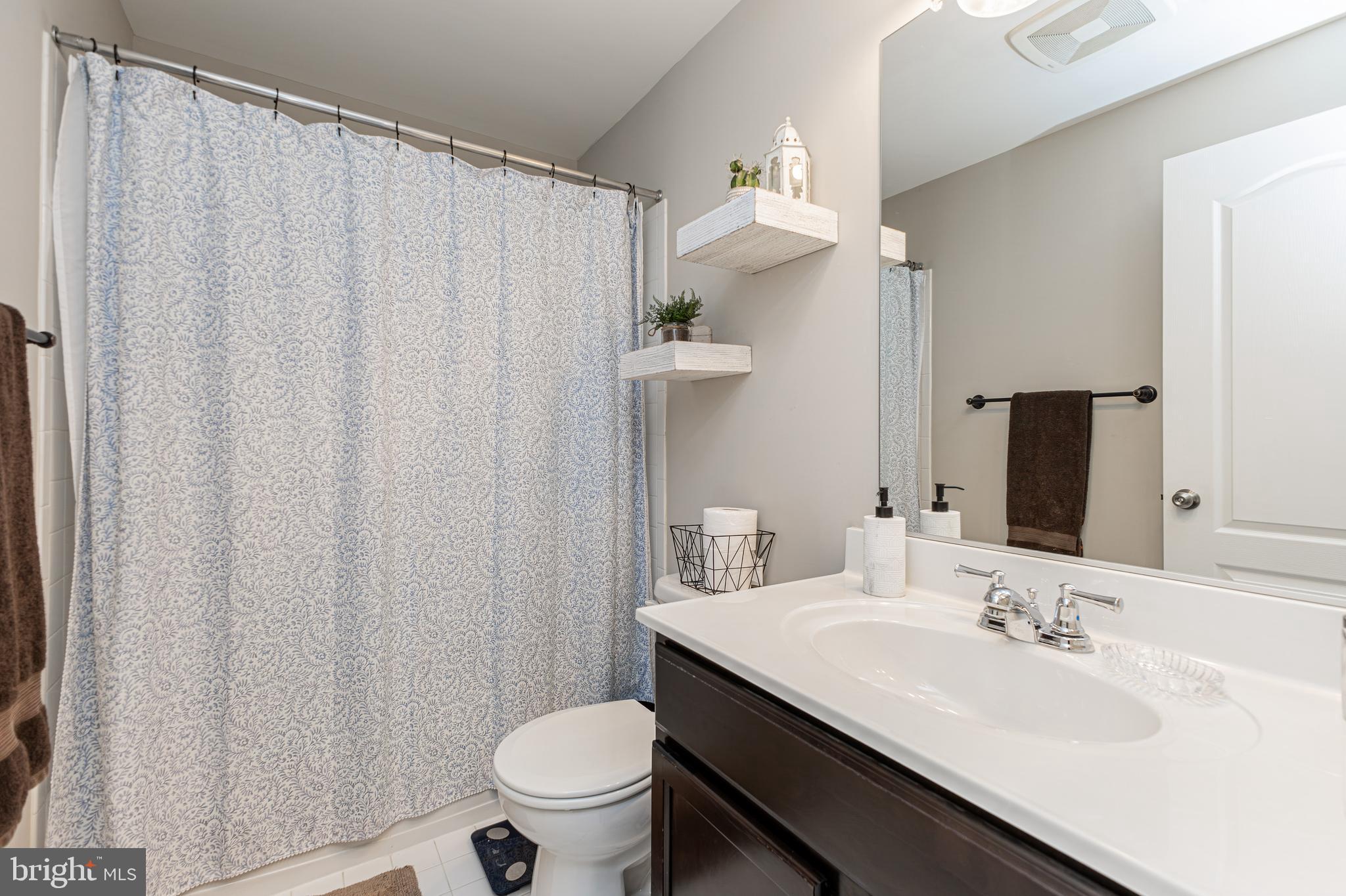 4336 Potomac Highlands Circle, Unit 51 Triangle, VA 22172 - Photo 21 of 40 a bathroom with a granite countertop sink toilet and a mirror