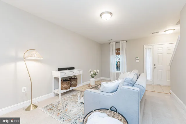 a living room with furniture fireplace and a mirror