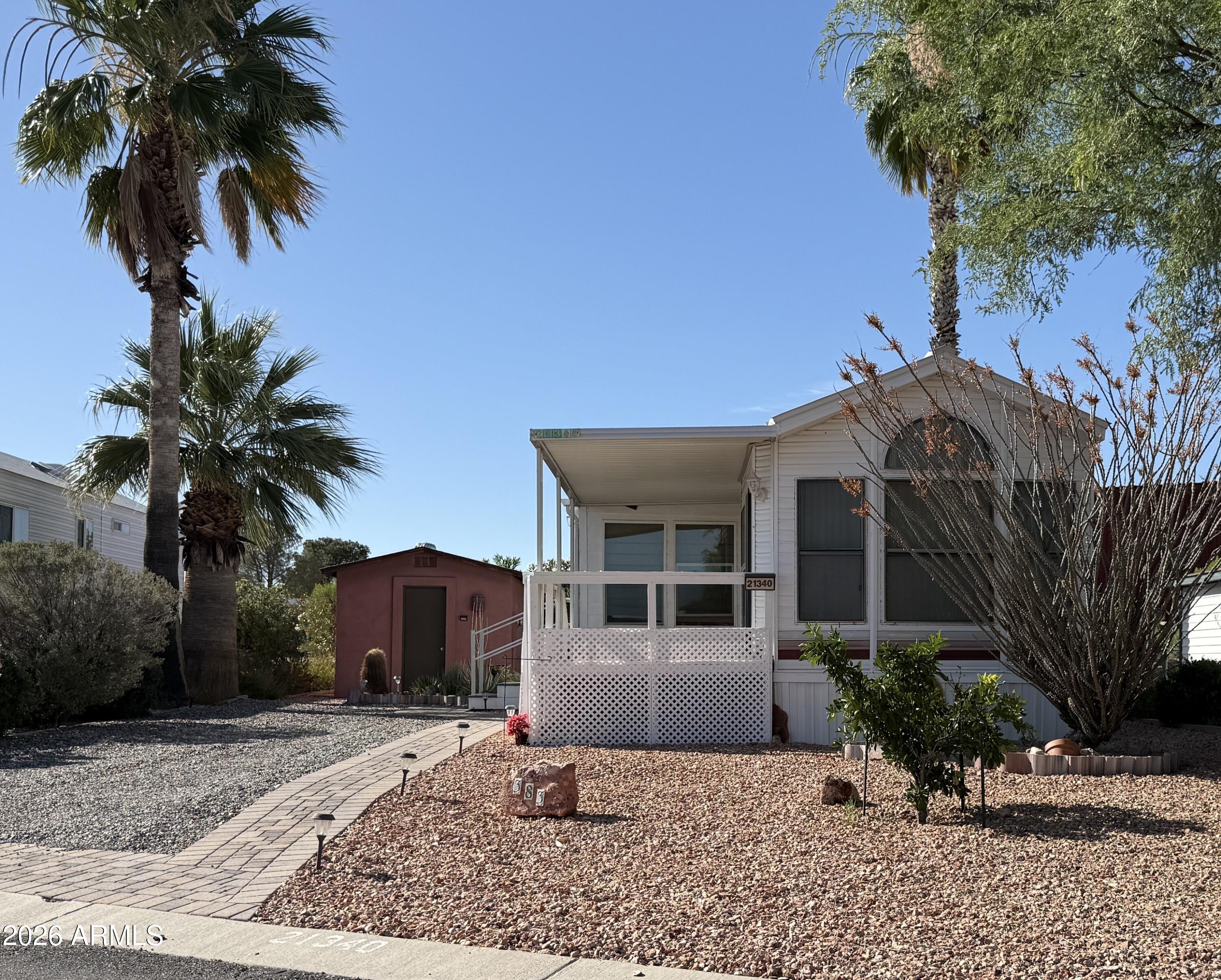 21340 Trading Post Trail Congress, AZ 85332 - Photo 1 of 31 a front view of a house with a yard and potted plants