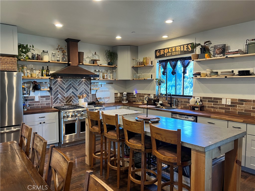 15445 Glenn Road Cobb, CA 95426 - Photo 1 of 1 a kitchen with stainless steel appliances granite countertop a stove and cabinets