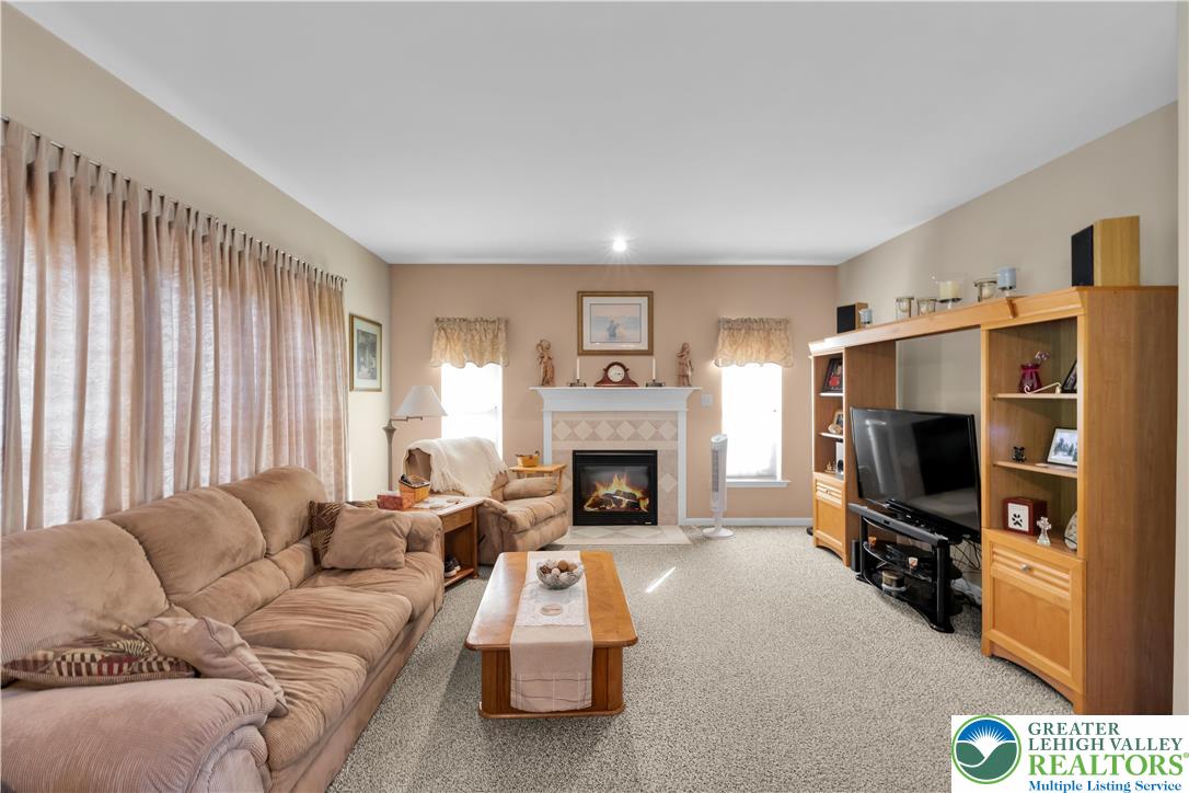 5920 Michael's Crossing Orefield, PA 18069 - Photo 12 of 31 a living room with furniture flat screen tv and a fireplace