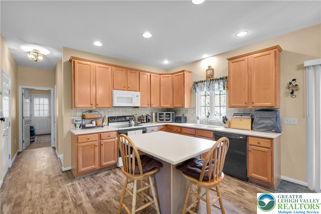 5920 Michael's Crossing Orefield, PA 18069 - Photo 13 of 31 a kitchen with a sink a stove a refrigerator cabinets and dining table
