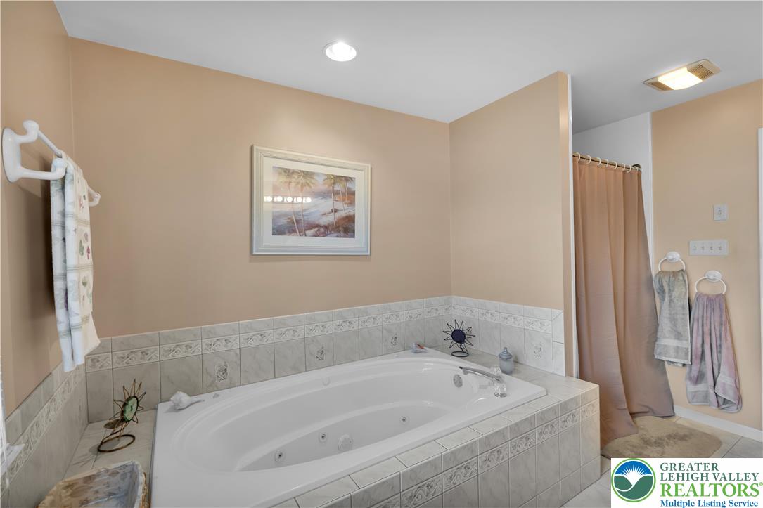 5920 Michael's Crossing Orefield, PA 18069 - Photo 21 of 31 a bathroom with a bathtub and a shower