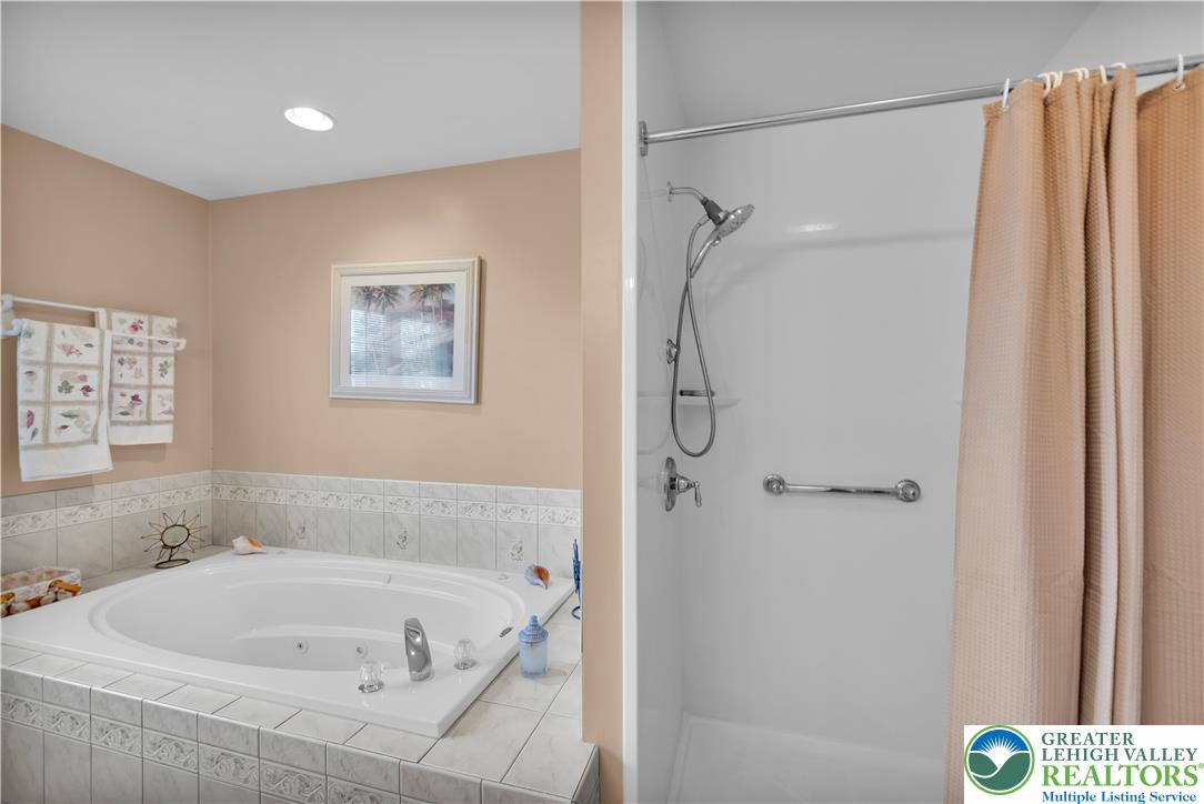 5920 Michael's Crossing Orefield, PA 18069 - Photo 22 of 31 a bathroom with a tub and a shower