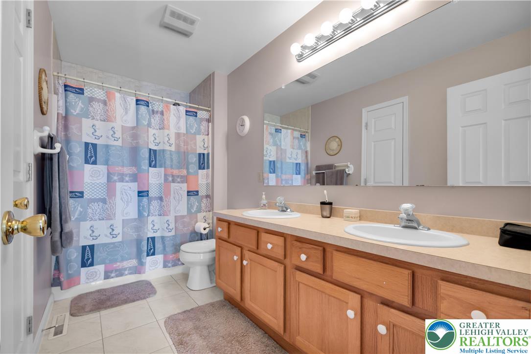 5920 Michael's Crossing Orefield, PA 18069 - Photo 24 of 31 a bathroom with a double vanity sink mirror and shower