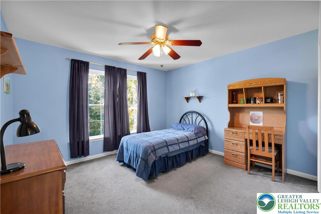 5920 Michael's Crossing Orefield, PA 18069 - Photo 25 of 31 a living room with a bed furniture and a window