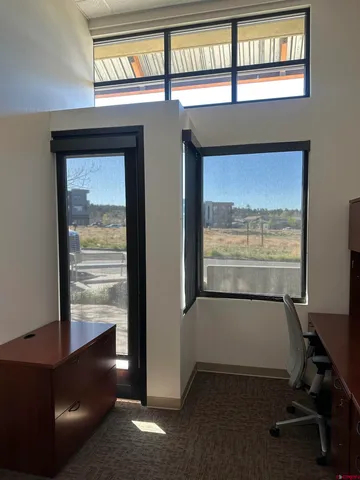 a view of a room with furniture and windows