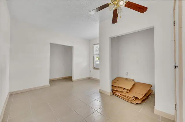 an empty room with a ceiling fan