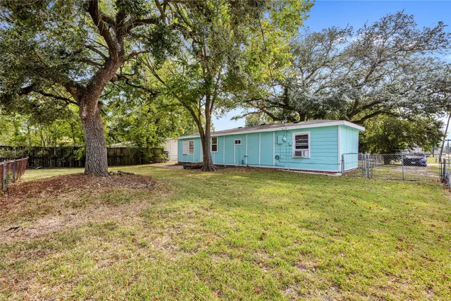 a view of a backyard with large trees