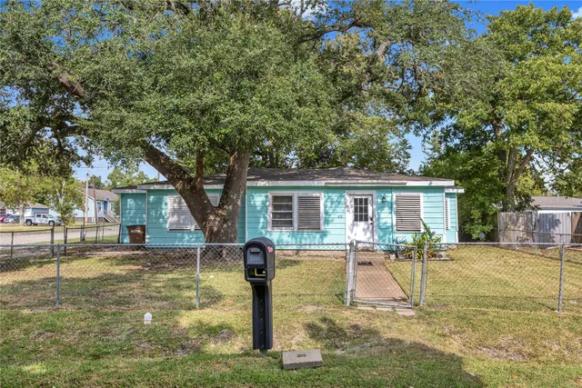 a front view of house with yard and trees