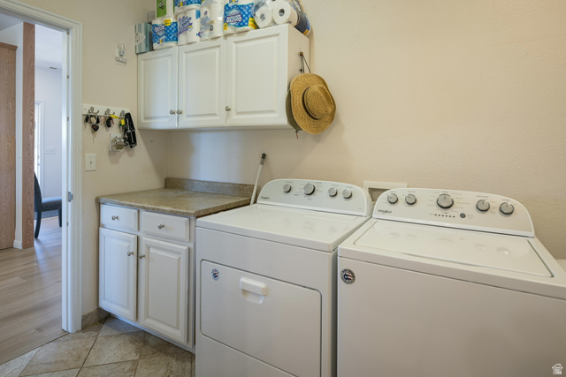 684 Blue Mountain Ridge Monticello, UT 84535 - Photo 42 of 71 Laundry area with washer and dryer, cabinet space, and light tile patterned floors